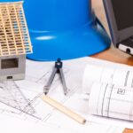 Electrical diagrams, accessories for engineer jobs and small house on desk, building home concept